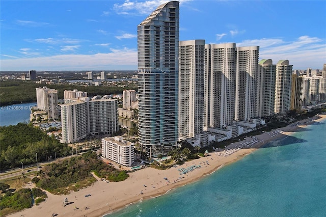 birds eye view of property featuring a water view and a view of the beach