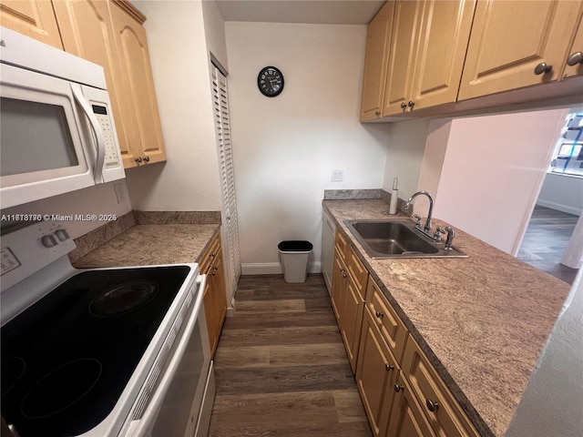 kitchen with light brown cabinetry, white appliances, dark wood-type flooring, and sink