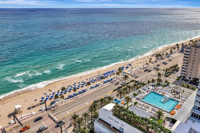 birds eye view of property featuring a view of the beach and a water view