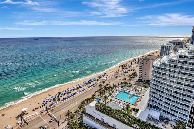 birds eye view of property with a water view and a beach view