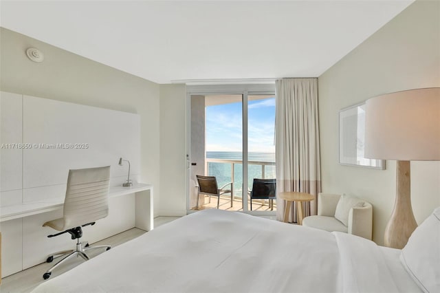 bedroom featuring access to exterior, floor to ceiling windows, and a water view