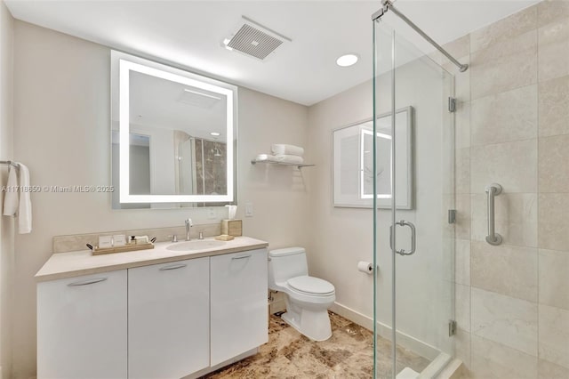 bathroom with vanity, an enclosed shower, and toilet