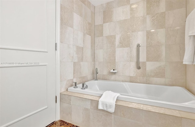 bathroom featuring tile walls and tiled bath