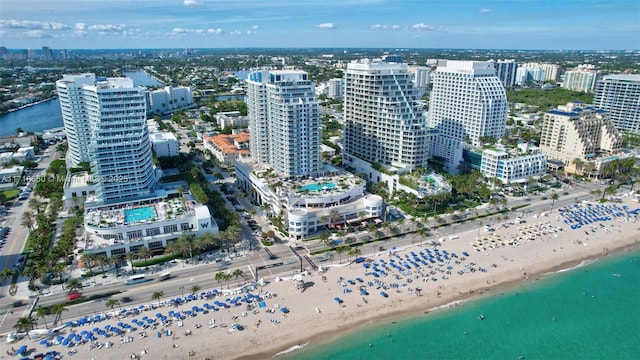 birds eye view of property featuring a view of the beach and a water view