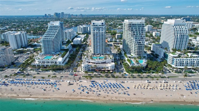 drone / aerial view with a water view and a beach view