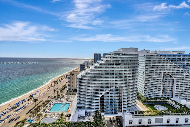 view of property with a water view and a view of the beach