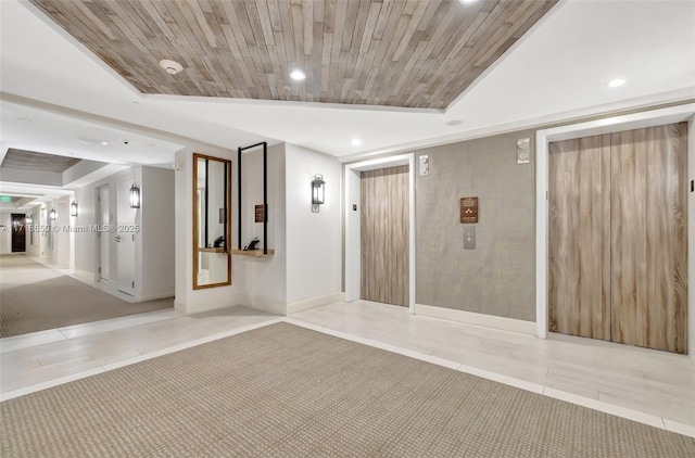 interior space with light tile patterned floors, elevator, and wood ceiling