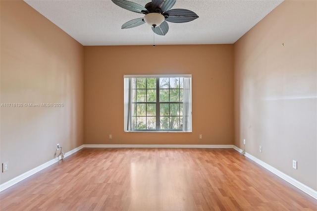 spare room featuring ceiling fan, light hardwood / wood-style floors, and a textured ceiling