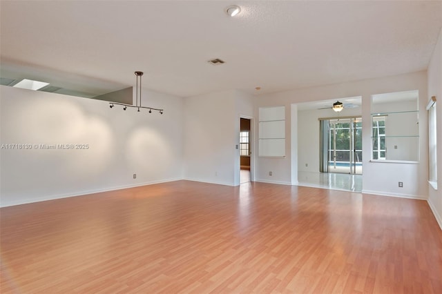 empty room featuring light hardwood / wood-style flooring and ceiling fan