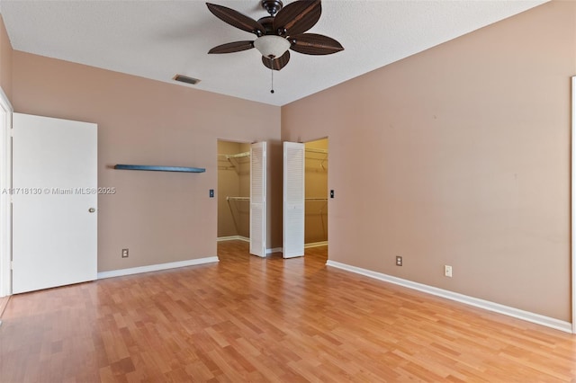 interior space with ceiling fan, a textured ceiling, and light hardwood / wood-style flooring