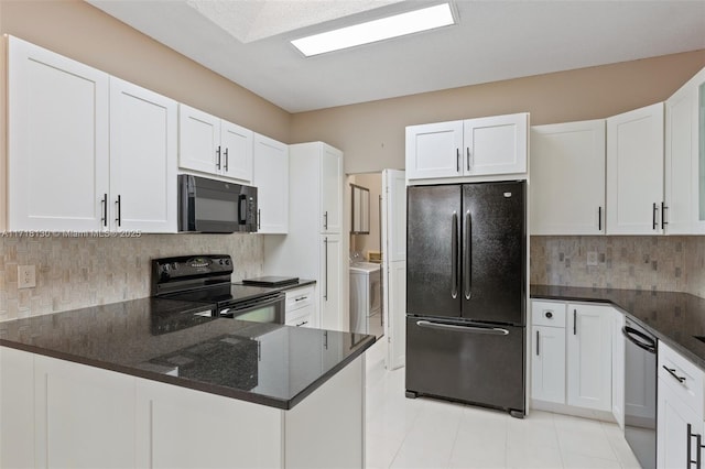 kitchen with tasteful backsplash, white cabinetry, and black appliances