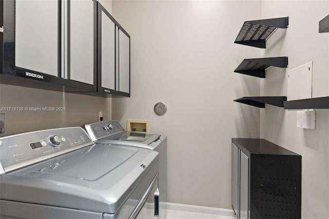 laundry room featuring cabinets and washing machine and clothes dryer