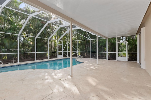 view of swimming pool featuring a lanai and a patio