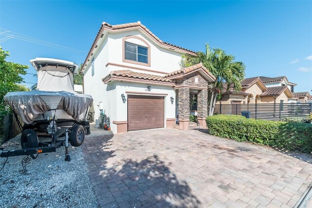 mediterranean / spanish-style home with a garage