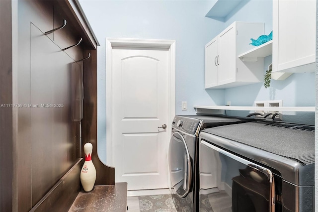 laundry area featuring cabinets and washer and dryer