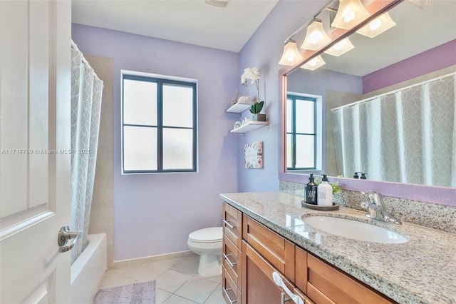 full bathroom featuring vanity, toilet, tile patterned flooring, and a wealth of natural light