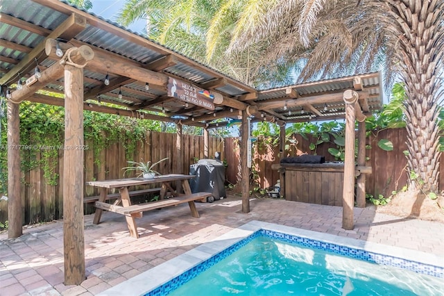 view of pool featuring an outdoor bar and a patio