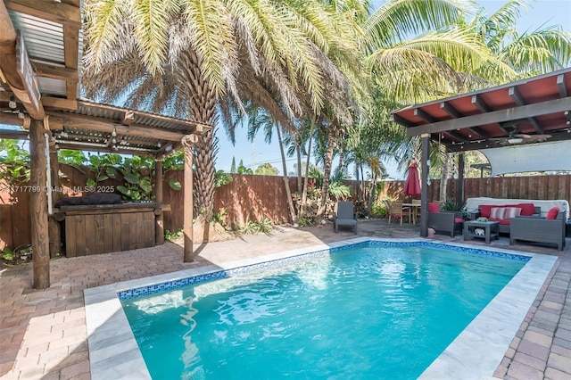 view of swimming pool with a patio, outdoor lounge area, ceiling fan, and a pergola