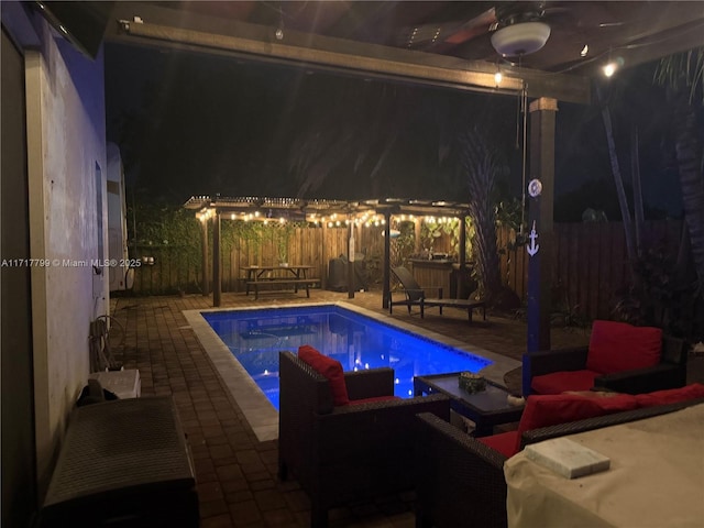 view of swimming pool featuring outdoor lounge area, a patio, and ceiling fan