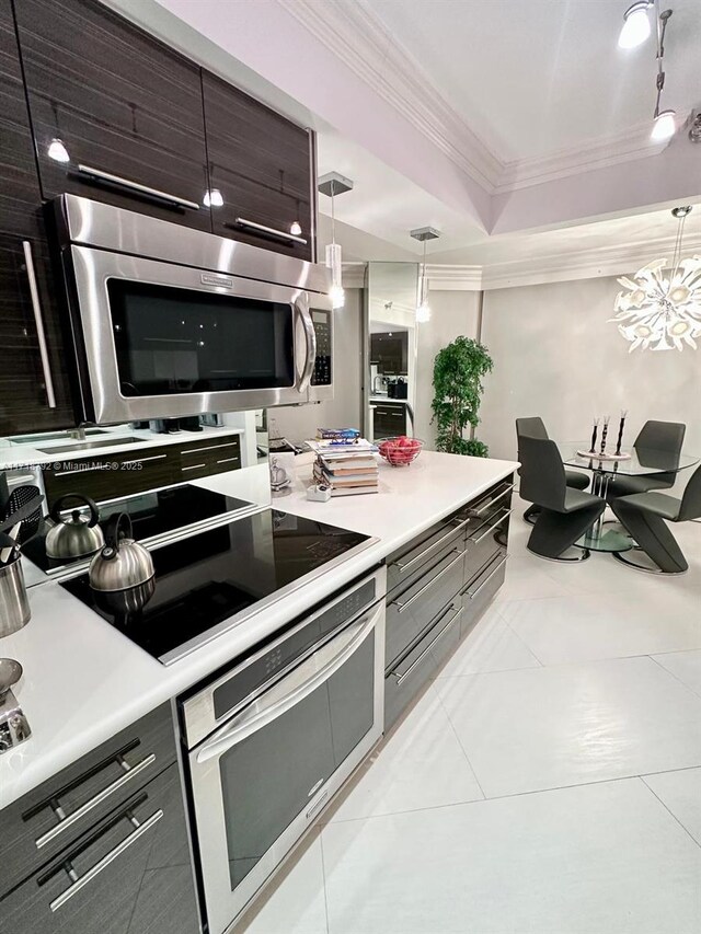 laundry area featuring washer and dryer and light tile patterned flooring