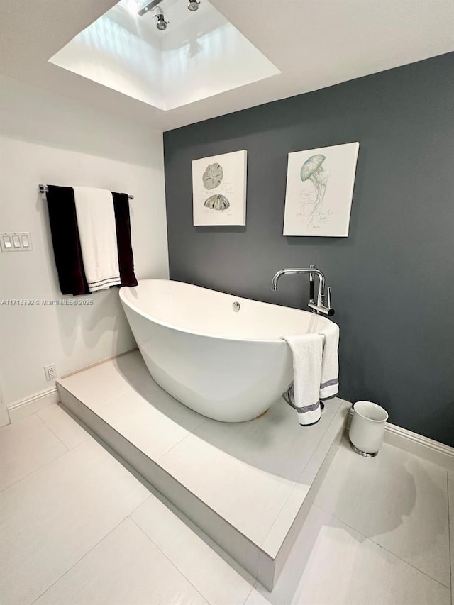 bathroom with tile patterned flooring and a tub