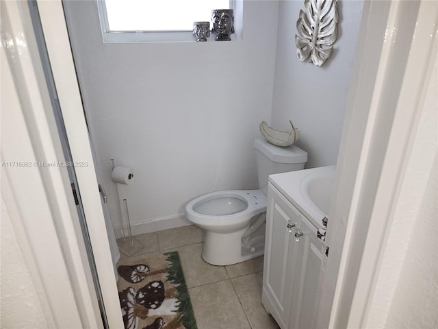 bathroom featuring tile patterned flooring, vanity, and toilet