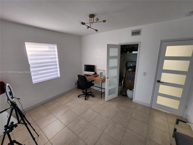 tiled office featuring a chandelier