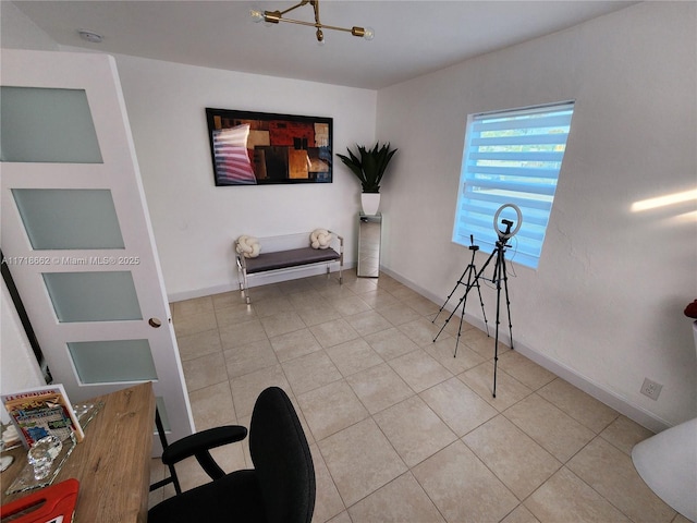 living area featuring light tile patterned flooring and an inviting chandelier