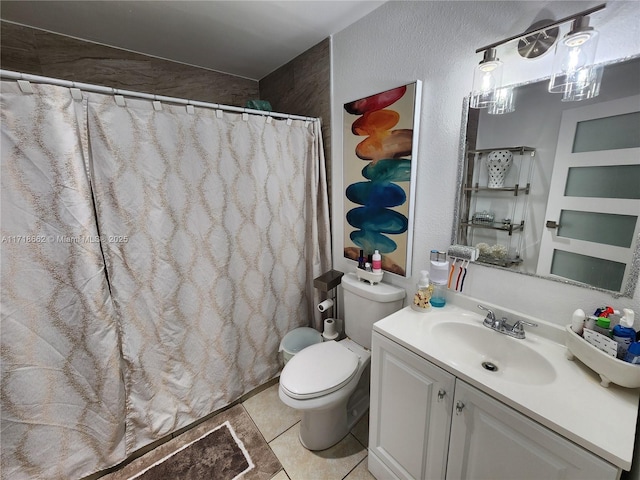 bathroom featuring toilet, vanity, tile patterned floors, and a shower with shower curtain