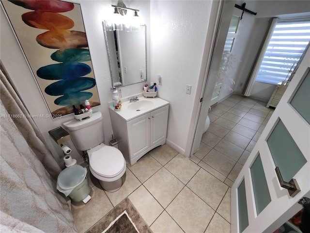 bathroom featuring tile patterned floors, vanity, and toilet