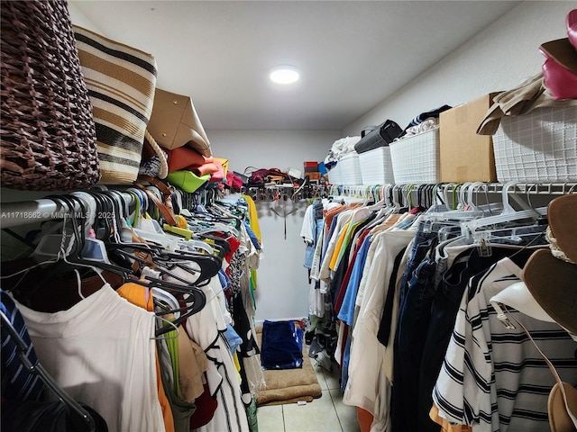 walk in closet with light tile patterned floors