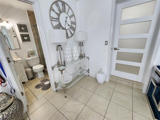 bathroom with tile patterned flooring and toilet