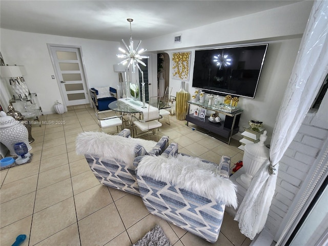 tiled living room with a chandelier