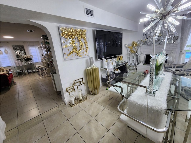 living room featuring tile patterned flooring and an inviting chandelier