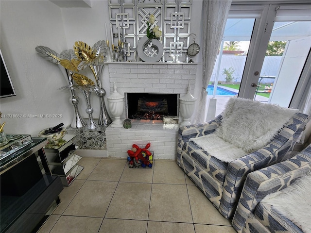 living room with a fireplace and light tile patterned floors