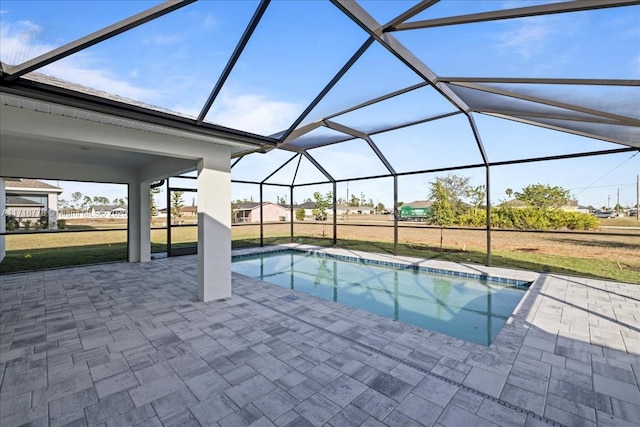 view of swimming pool with a lanai, a patio area, and a lawn