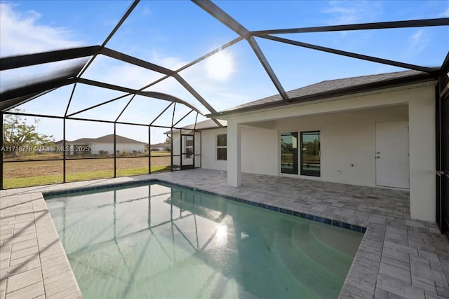 view of swimming pool featuring a lanai and a patio