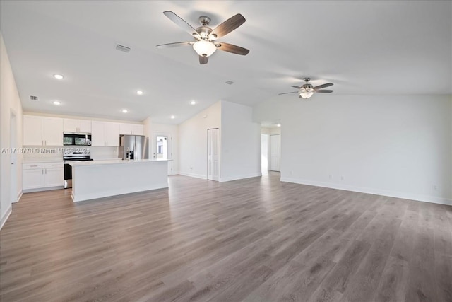 unfurnished living room featuring light hardwood / wood-style floors, ceiling fan, and vaulted ceiling