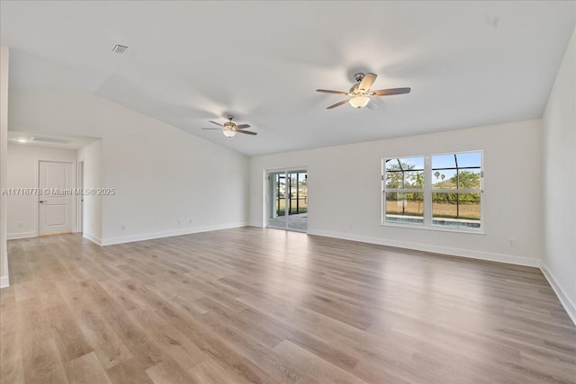 empty room with ceiling fan, vaulted ceiling, and light hardwood / wood-style flooring