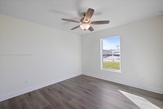 spare room with ceiling fan and dark hardwood / wood-style flooring