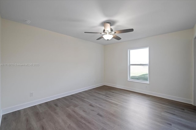 spare room featuring hardwood / wood-style flooring and ceiling fan