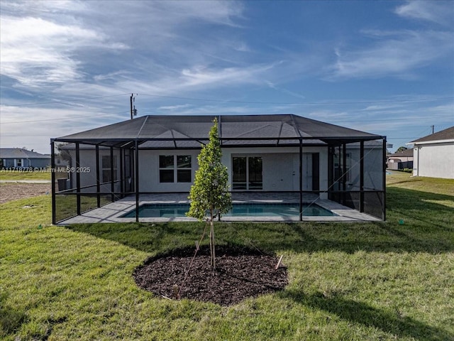 rear view of property featuring a lawn, a patio, and glass enclosure