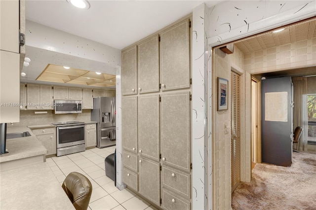 kitchen with light tile patterned flooring and stainless steel appliances