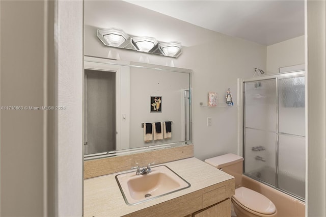 full bathroom with vanity, toilet, and bath / shower combo with glass door