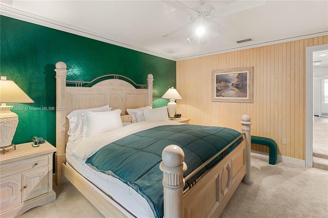 carpeted bedroom featuring ceiling fan and ornamental molding