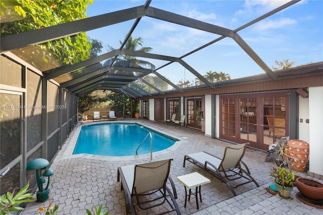 view of pool featuring french doors, a patio area, and a lanai