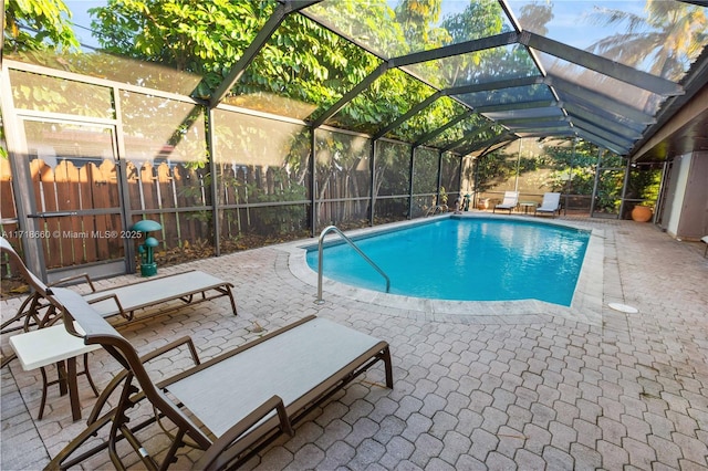 view of pool featuring a patio and glass enclosure