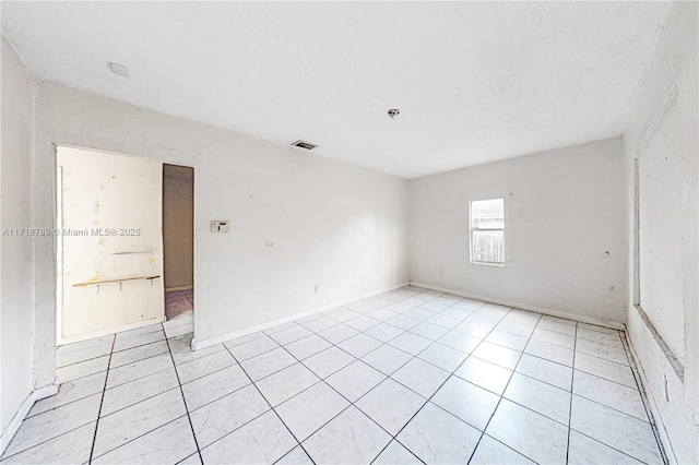 empty room featuring light tile patterned floors