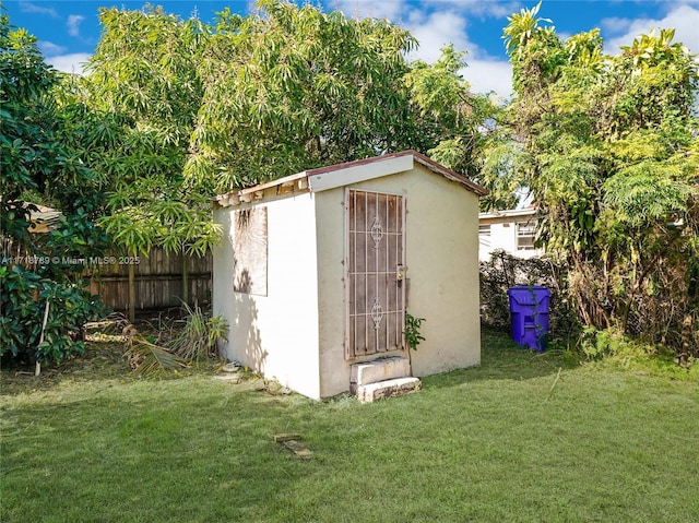 view of outbuilding with a lawn