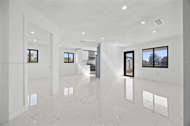 unfurnished living room featuring a textured ceiling